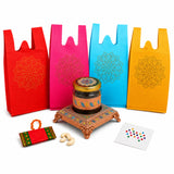 Ornate golden glass jar with intricate floral patterns and matching lid on a copper stand in varalakshmi vratham gift hamper