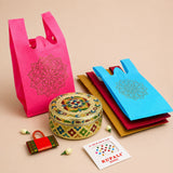 A vibrant pink reusable non-woven shopping bag with gold foil mandala design from varalakshmi vratham gift hamper for women