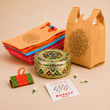 Ornate round gold and multicolored enamel tin with intricate floral patterns in Varalakshmi Vratham gift hamper for women