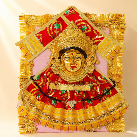 Varalaxmi goddess face set with vibrant red and gold embroidery green floral accents and fringed border for pooja rituals