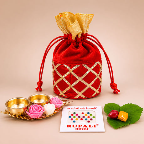 Red velvet drawstring pouch with gold metallic lattice pattern and golden ribbon tie for varalakshmi vratham gift hamper