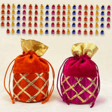 Assorted orange and magenta velvet potli bags with gold gota patti lattice work and drawstring ties for festive occasions