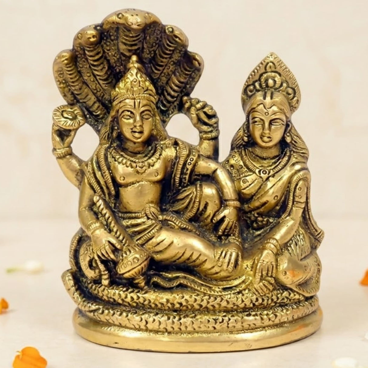 Golden brass statue of lord vishnu and lakshmi ji seated with a coiled shesha naag for mandir pooja and home temple