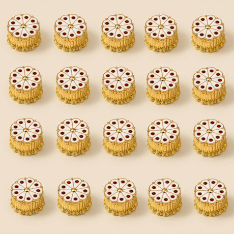 White haldi kumkum plastic holder with gold-toned circular beads, white enamel center, and red gemstone accents for rituals