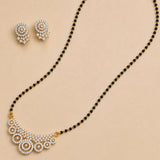 White stone mangalsutra necklace set with gold-toned crescent pendant, sparkling stones, black beads, and matching earrings