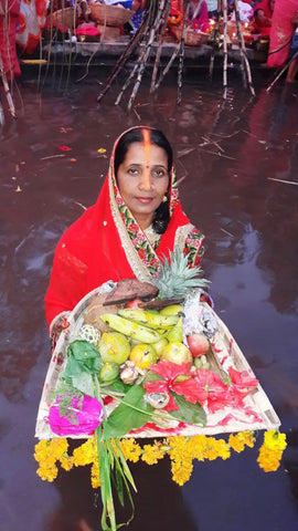 Women doing chhat pooja withSoop (Bamboo Baskets)