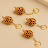 Four wooden fish-shaped keychains with gold-toned metal chains and rings for good luck and key holding gifts
