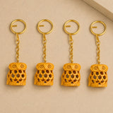 4pc wooden keychain set featuring intricately carved golden owl with warm amber hue as part of thanksgiving amulets
