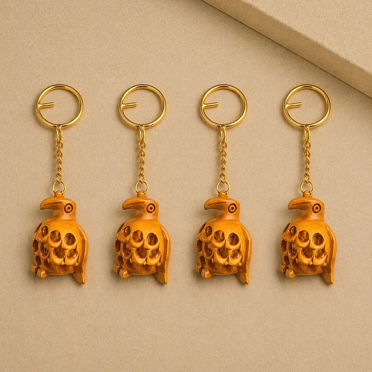 Golden bird-shaped wooden keychains with intricate carved details and polished metallic finish for thanksgiving use