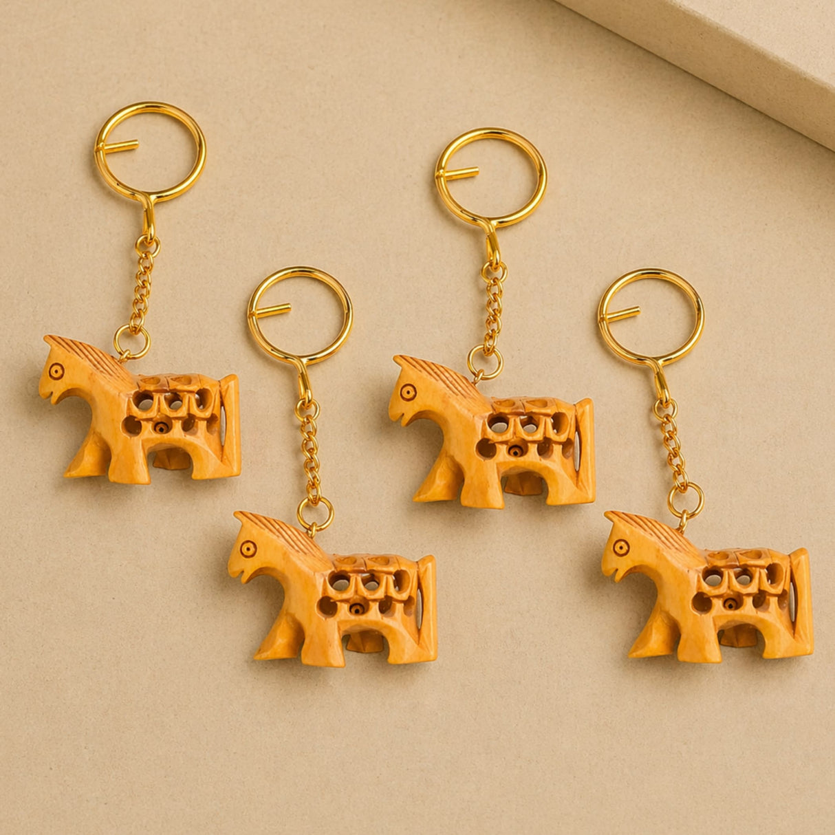 Golden horse-shaped wooden keychains with intricate carved details and warm amber hue for thanksgiving gift sets