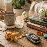 Gold-colored wooden horse keychain with intricate carvings attached to a car key fob from 4pc thanksgiving set