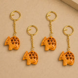 Orange carved wooden armadillo keychains with gold-toned metal rings for thanksgiving key holder set