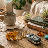 Gold-colored tortoise-shaped metal keychain attached to car key fob from 4pc wooden animal amulet keyring set