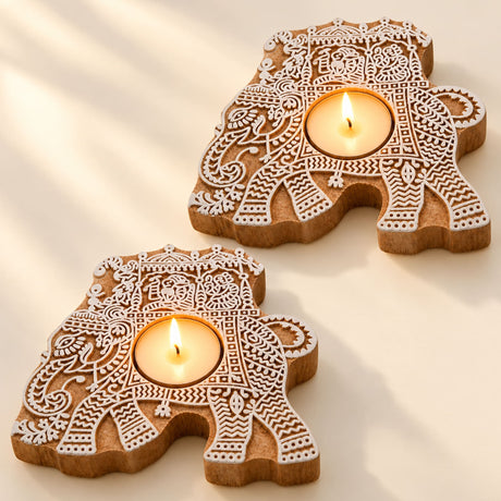 Handcrafted wooden elephant tealight holders with intricate white carved patterns for festive home decor and gifting