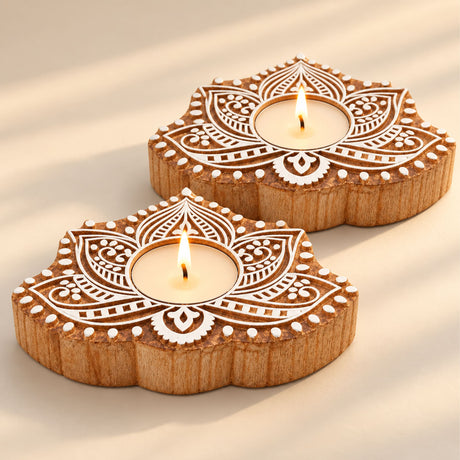 Two handcrafted wooden tea light holders with white lotus block print design for festive home decor and gifting