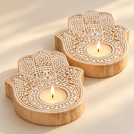 Handcrafted wooden hand-shaped tea light candle holders with intricate white laser-cut designs for festive decor