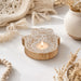 A wooden hamsa hand-shaped tea light candle holder with intricate carvings for deepawali and housewarming gifts