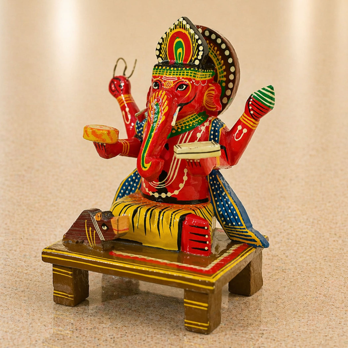 Wooden ganesha statue kondapalli hand painted with red body green and gold accents seated on tiger for pooja and home decor