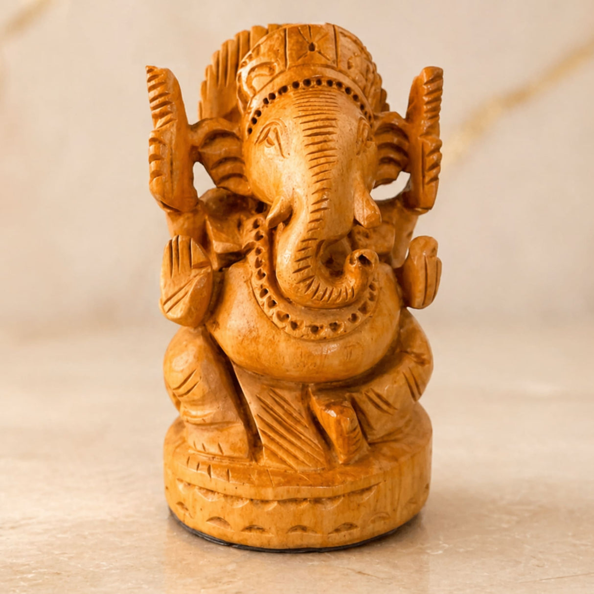Hand carved wooden ganesha idol with intricate details and warm golden brown finish for pooja and home decor