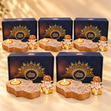 Wooden hand-shaped hamsa tea light candle holders with intricate white carvings and ganesha figurine in diwali gift hamper