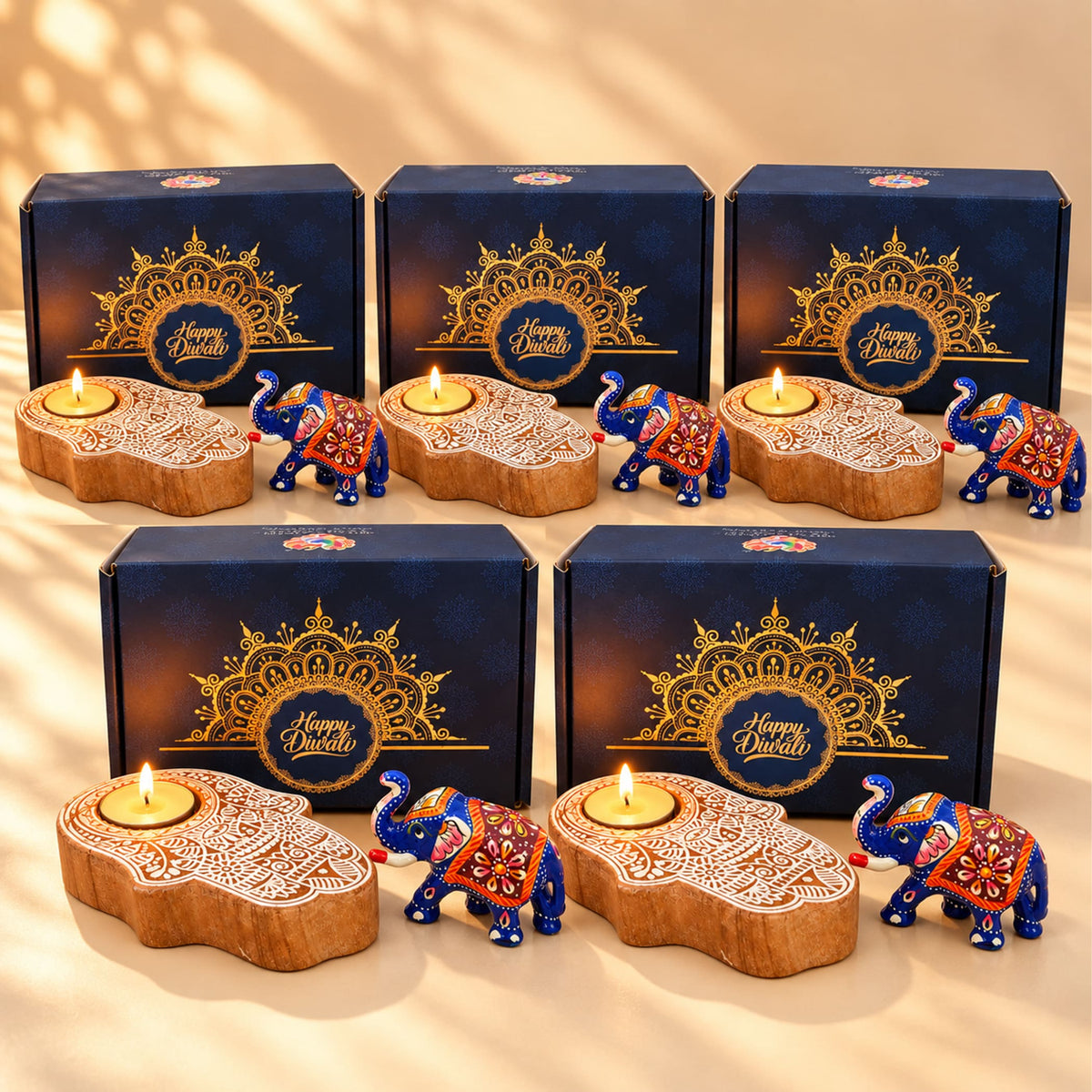 Diwali gift hamper featuring blue and orange painted elephant figurines with intricate floral designs and wooden hamsa candle holder