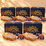 Diwali gift hamper featuring blue and orange painted elephant figurines with intricate floral designs and wooden hamsa candle holder
