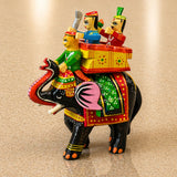 Hand-painted wooden Kondapalli elephant figurine with three riders in vibrant traditional attire for home decor