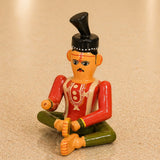 Hand-painted wooden kondapalli groom figurine in red and green with black hat for traditional etikoppaka golu decor