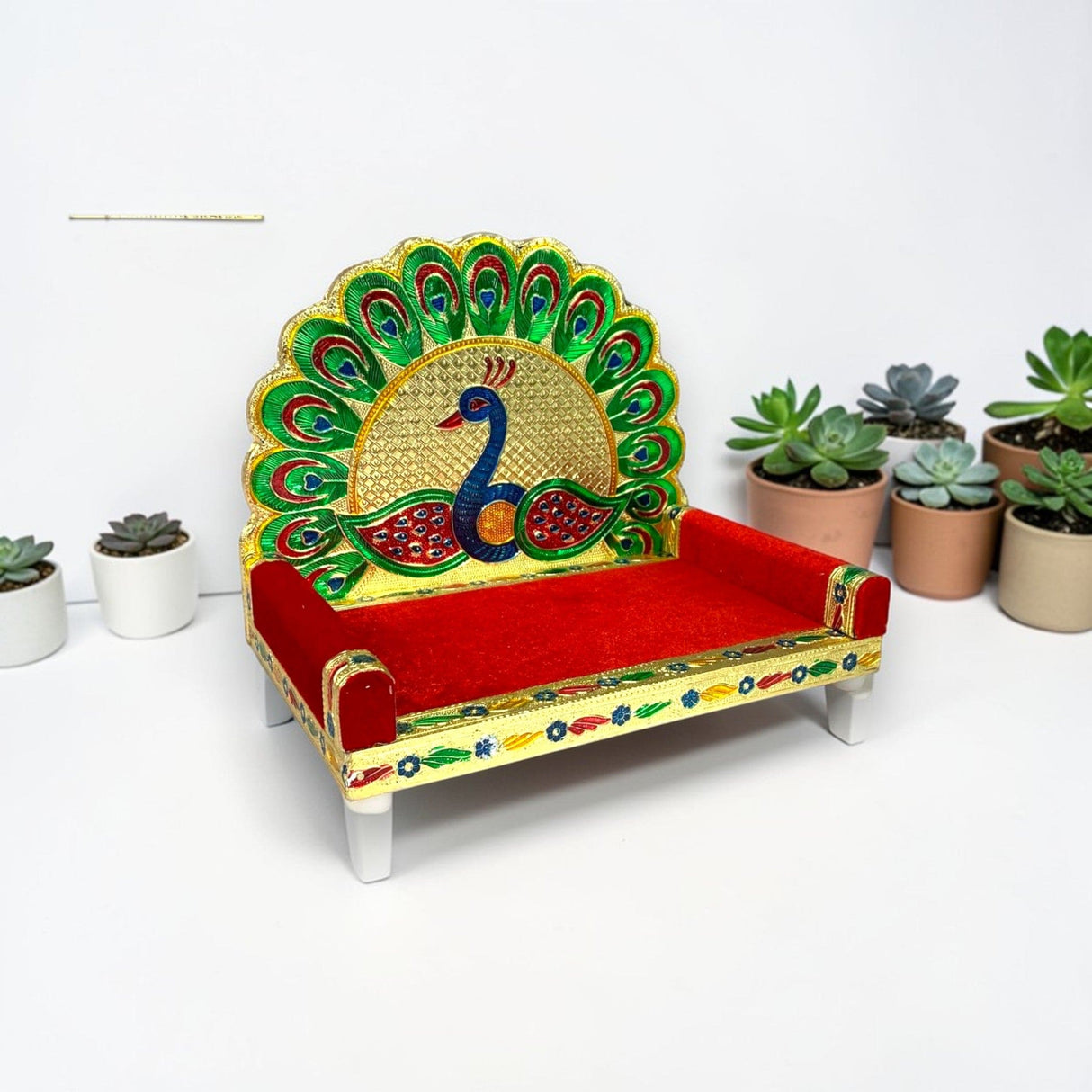 Wooden laddu gopal sinhasan peacock design with vibrant red velvet and gold-embellished intricate feathers for pooja mandir