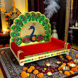 Wooden laddu gopal sinhasan with peacock design gold-trimmed frame and red velvet cushion for pooja mandir use