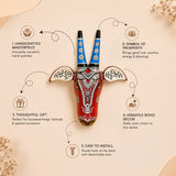 Vibrant red hand-carved wooden cow nandi wall hanging with blue horns and black-and-white ornate detailing for boho decor