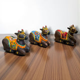 Handmade painted wooden Nandi cow idol with ornate saddle, 7.5 inch statue