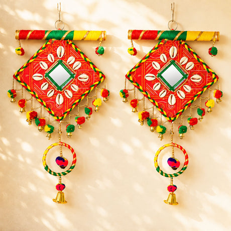 Wooden Rajasthani wall hanging tapestry in vibrant red green and yellow with central mirror and shell motifs for home decor