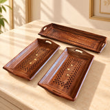 Set of three hand-painted rectangular wooden serving trays with carved star patterns and gold accents for dining use