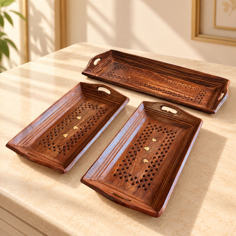Set of three hand-painted rectangular wooden serving trays with carved star patterns and gold accents for dining use