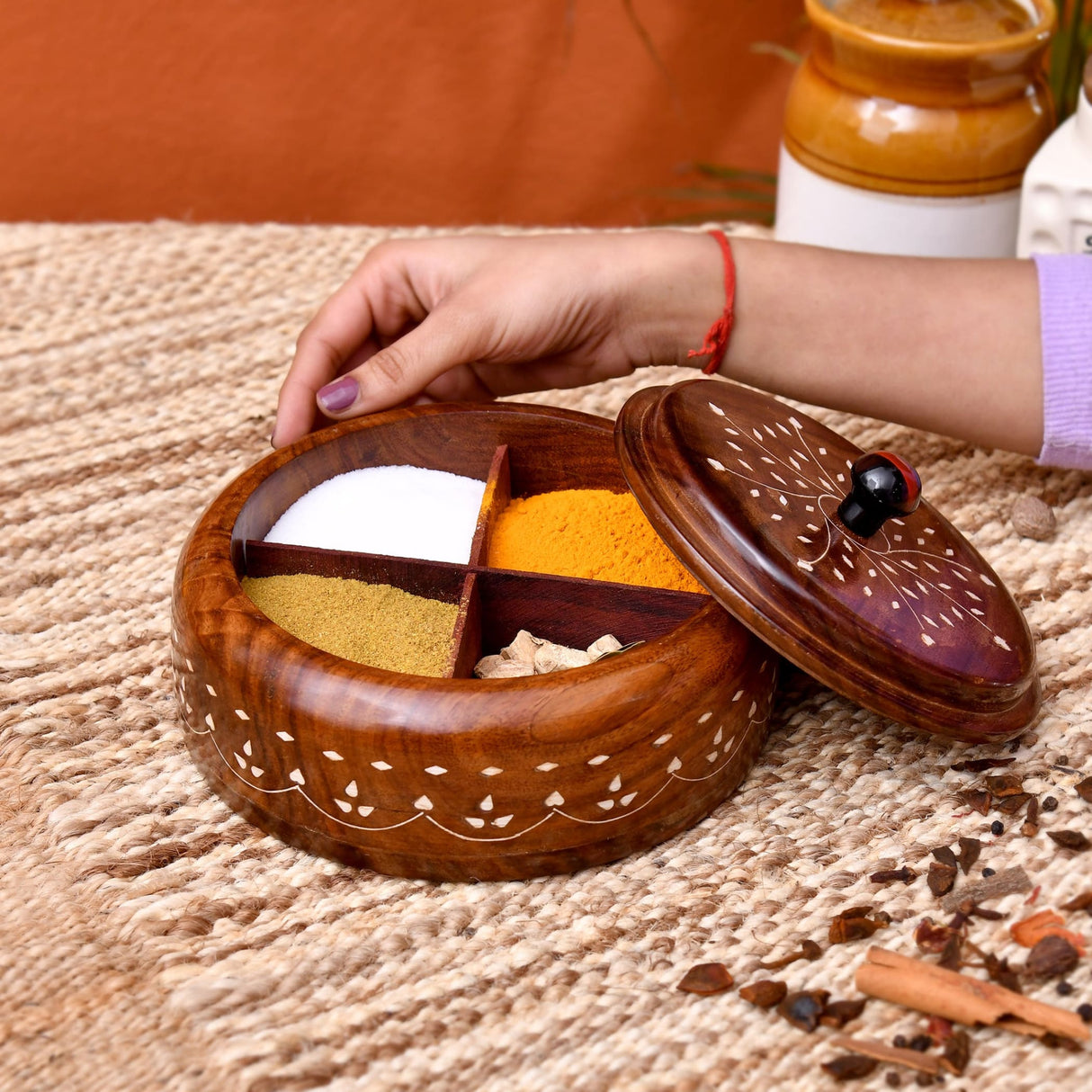 Round wooden Indian spice box organizer with hand-carved white inlay and four compartments for herbs and dry fruits storage