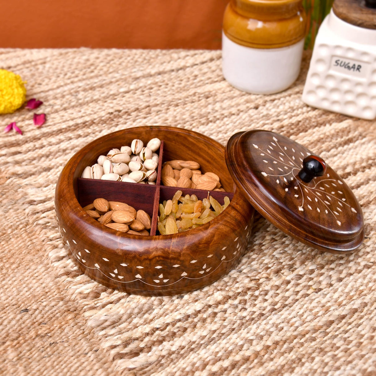 A round wooden Indian spice box organizer with dark brown finish, white inlay, and four compartments for herbs storage
