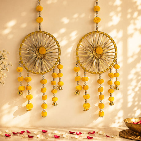 Golden circular woollen ring wall hanging with yellow pom-poms and small bells for traditional home decor