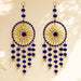 Blue and gold chandelier style earrings with intricate radial patterns pom pom accents and dangling bells for festive decor