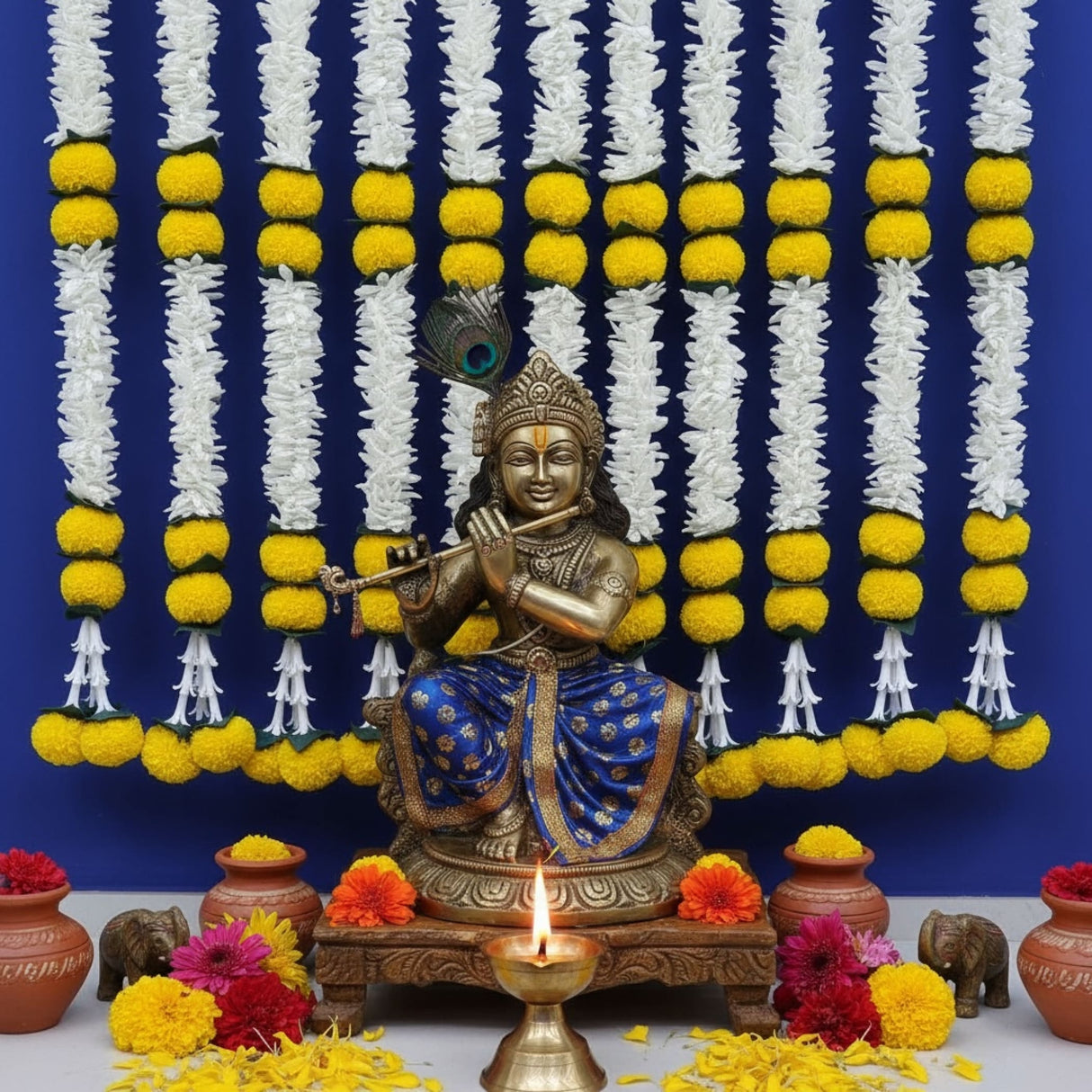 Golden flute-playing deity statue with peacock feather headpiece in blue and gold attire