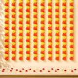 Artificial yellow orange marigold string garlands arranged in alternating vertical rows for Diwali and wedding decor