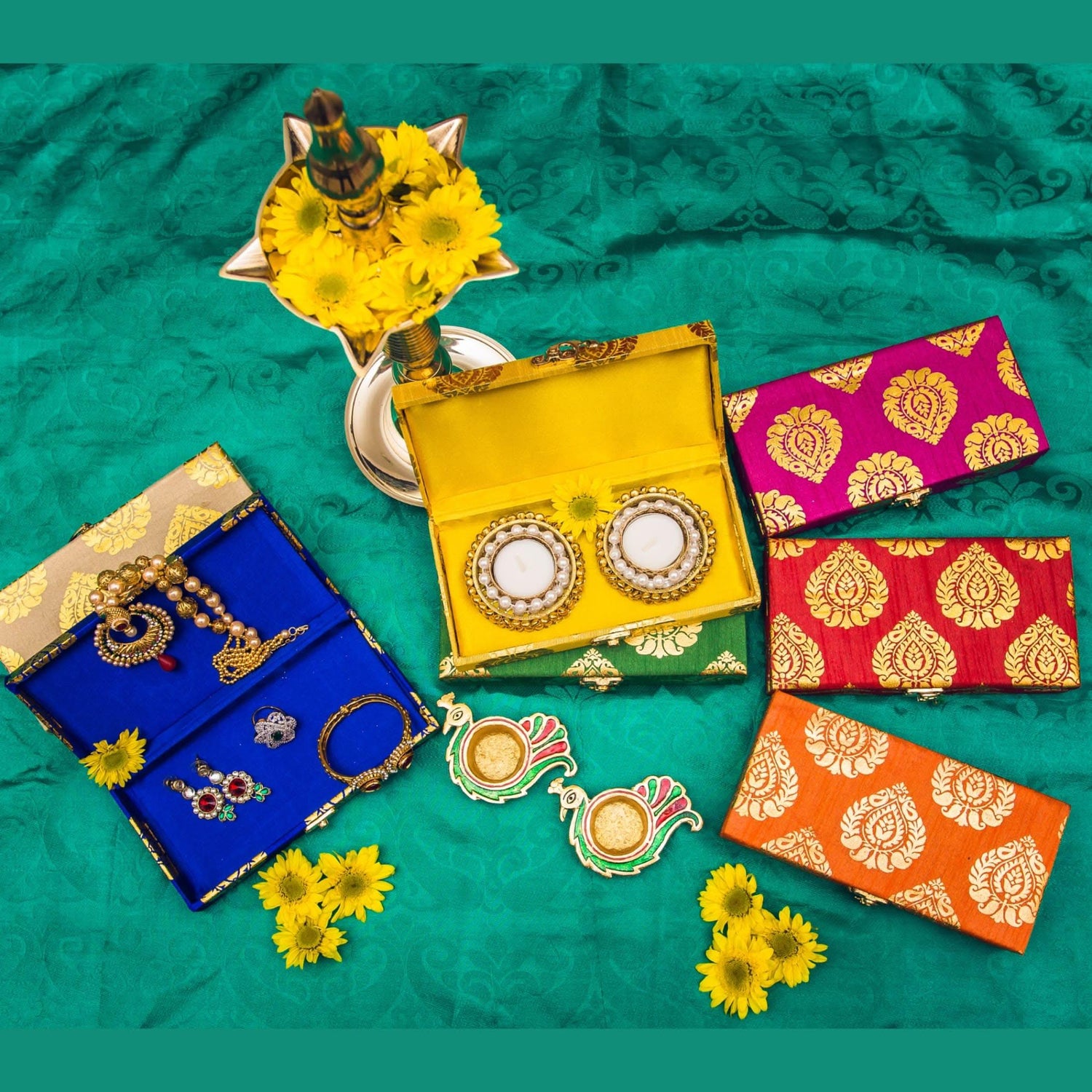 Vibrant yellow brocade jewelry organizer box with gold-patterned lid holding two ornate white mirrors for wedding favors